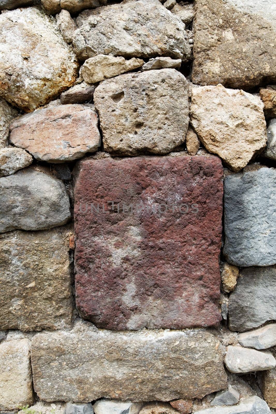 stone wall made from various colors of local rock, limestone, sandstone, lava ash, Goreme, Turkey almost dry wall