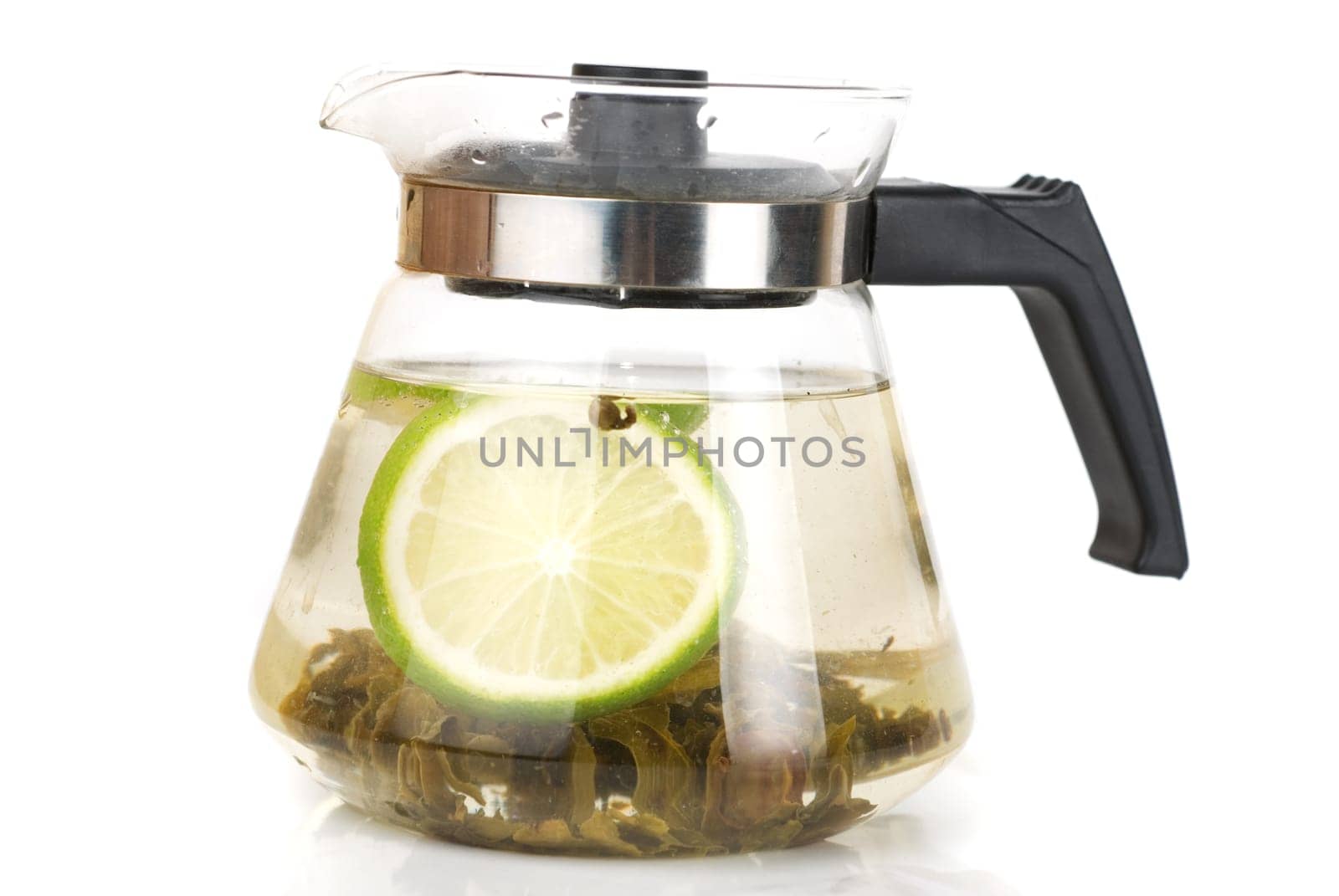 Teapot with green tea and lime isolated on a white background