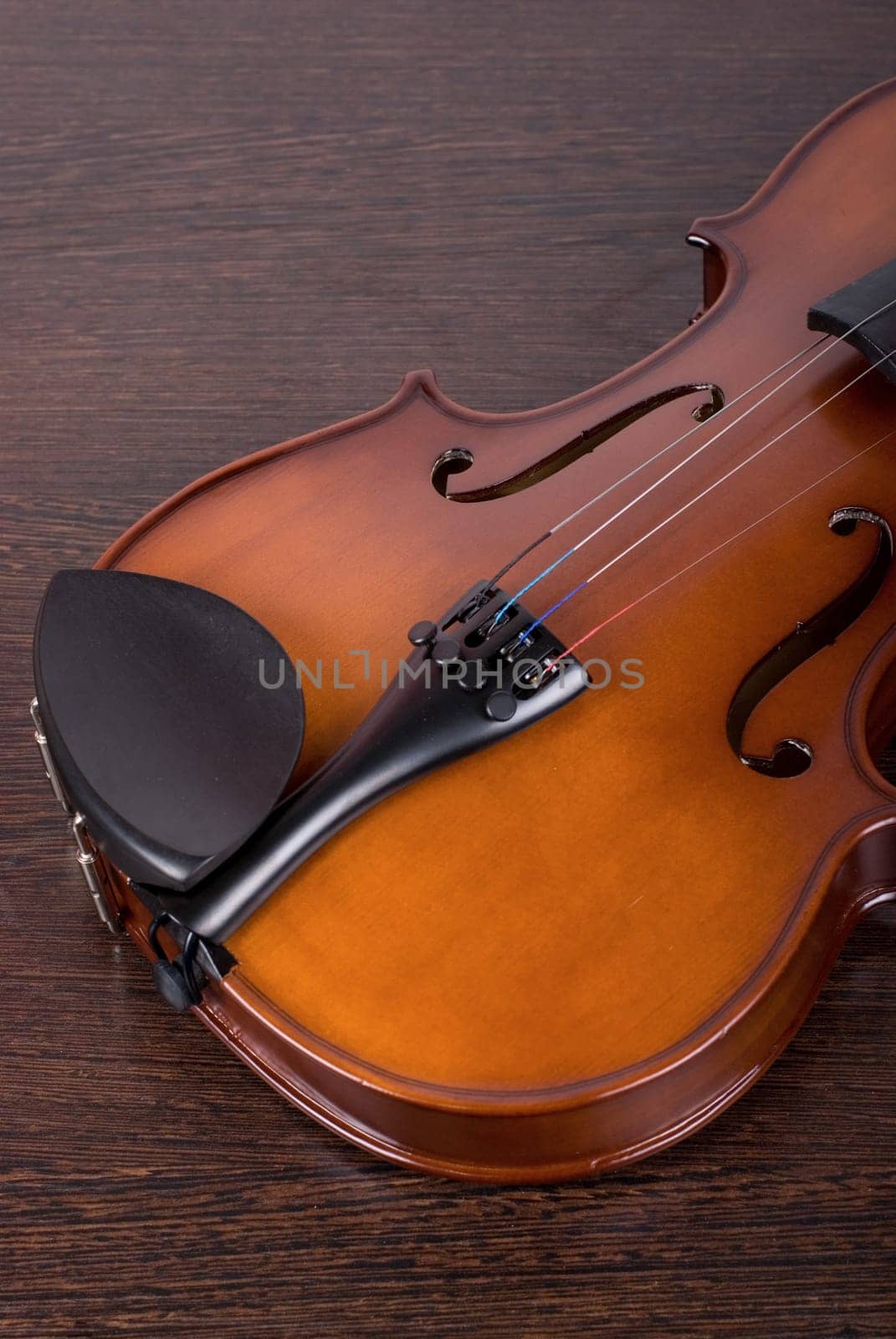 classic violin closeup on a brown wooden background