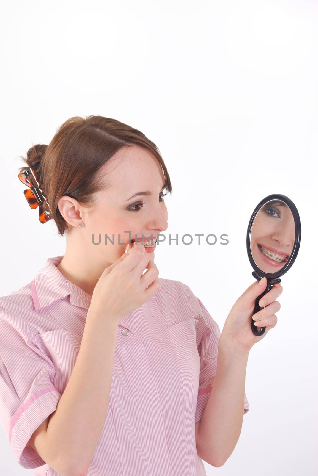 girl with braces cleaning teeth