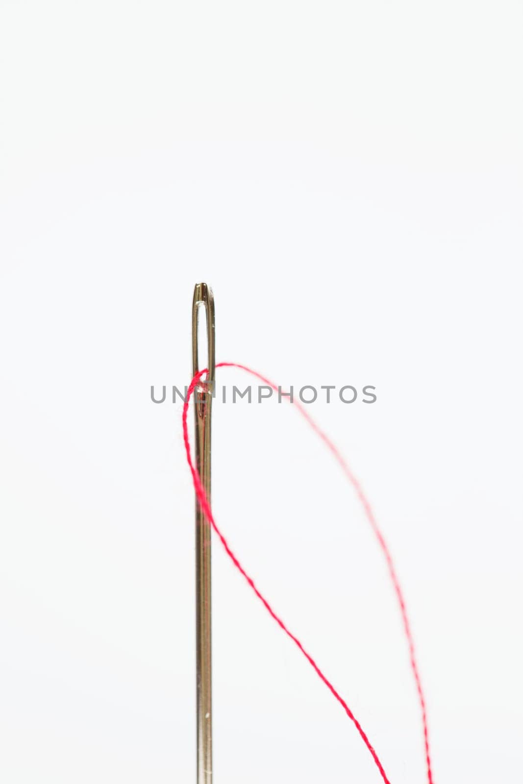 Sewing needle with red thread