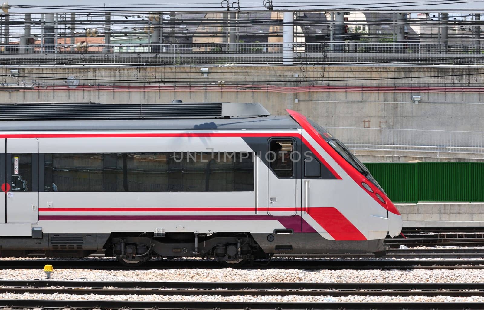Passenger train just arriving at Atocha railway station in Madrid (Spain)