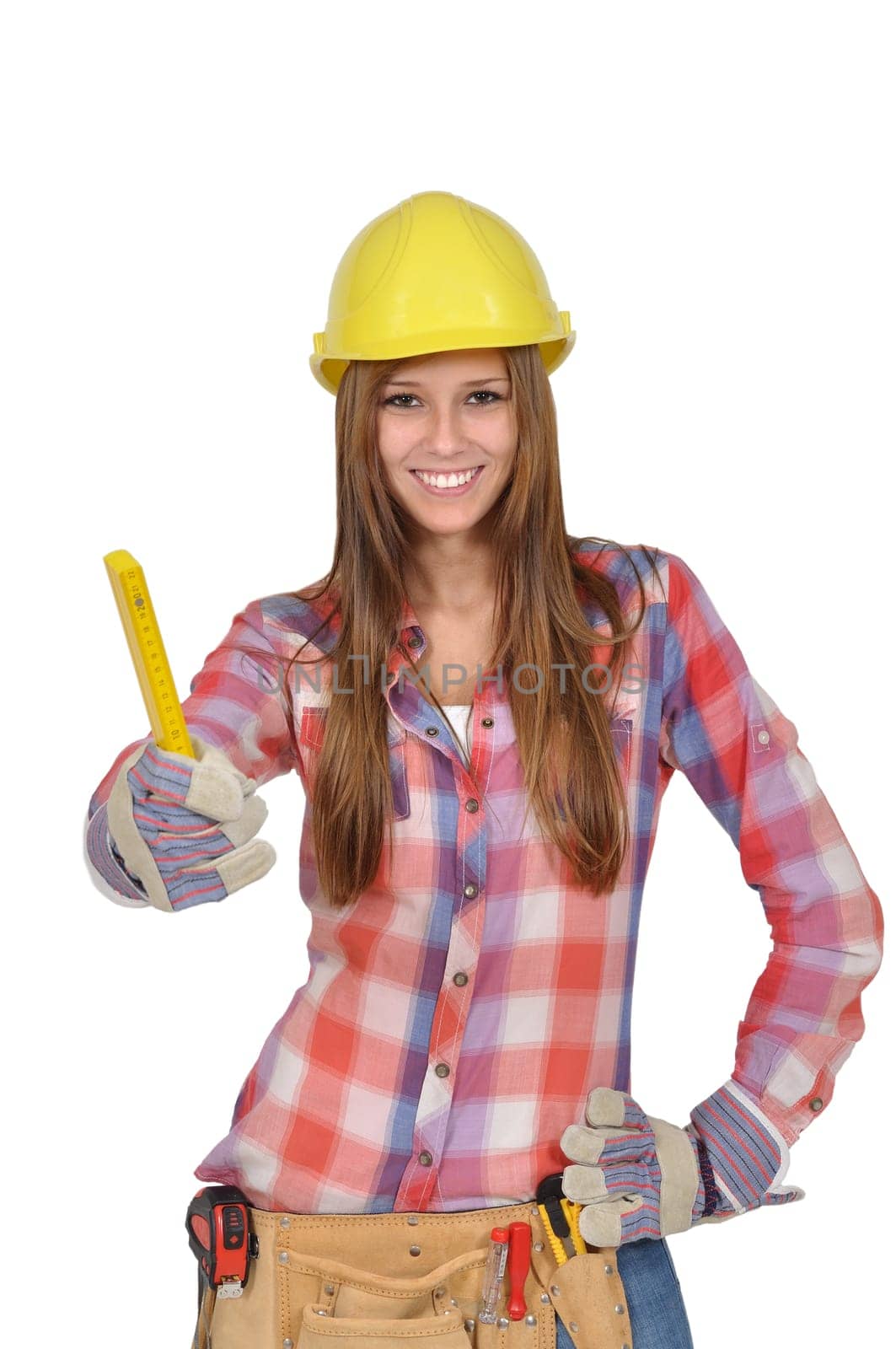 Young woman with a yellow helmet holds up a ruler