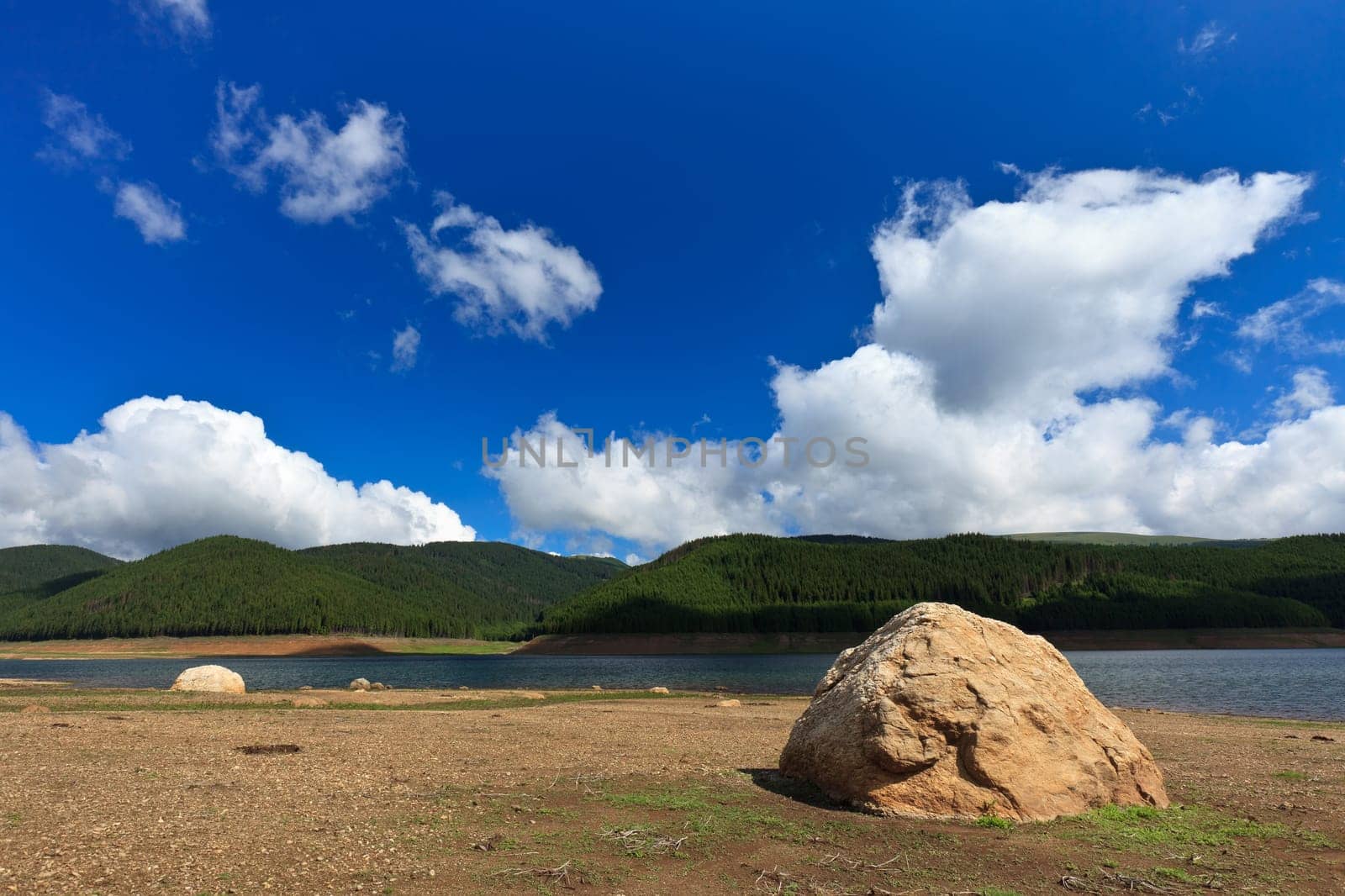 mountain lake and a blue sky with clouds