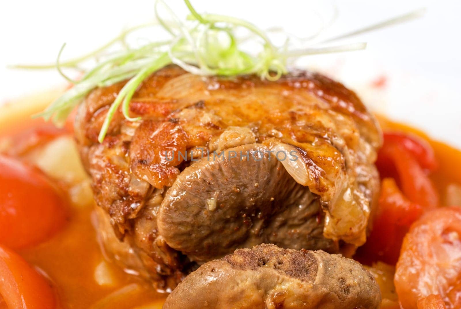 knuckle of veal baked with vegetables closeup