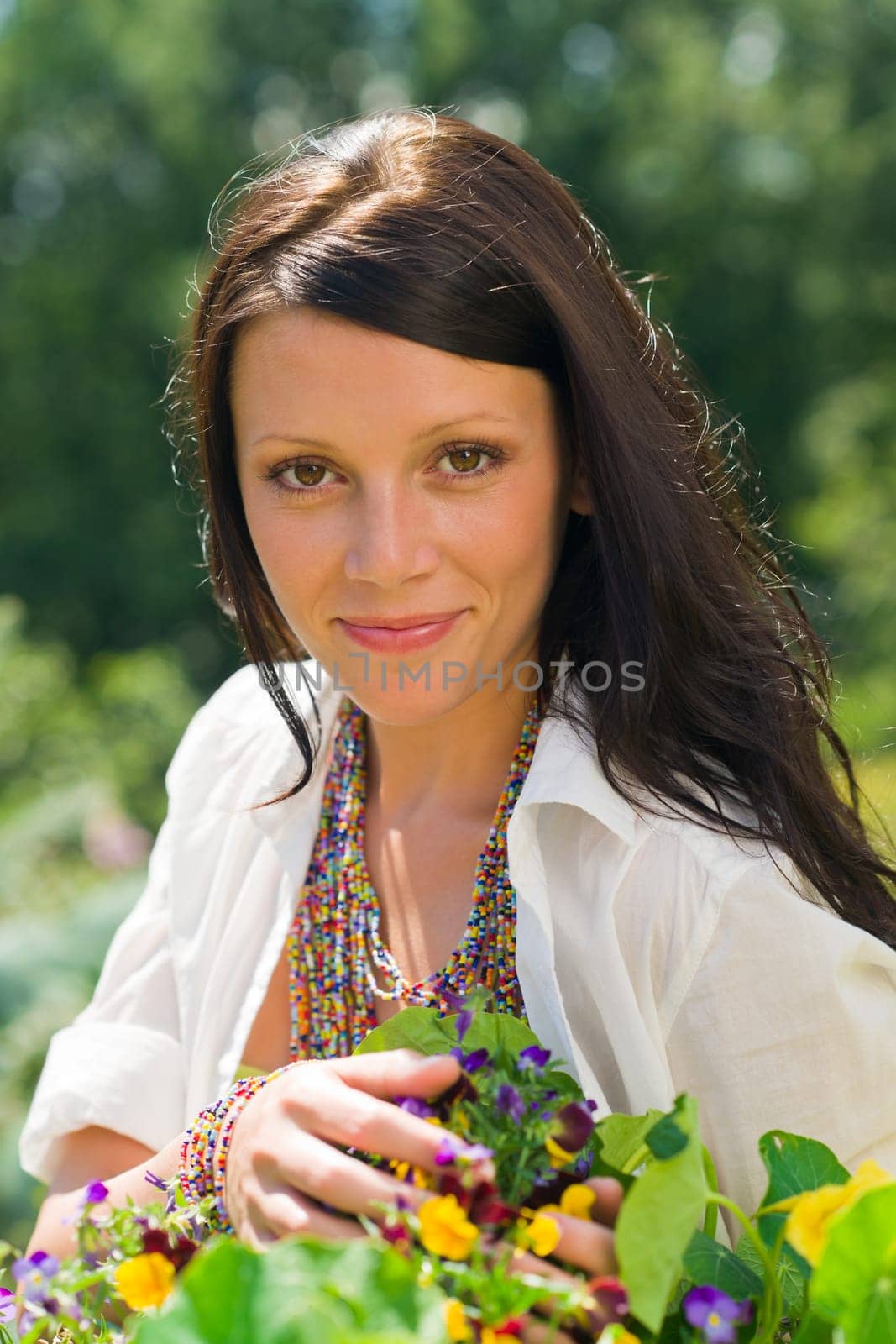 Summer garden beautiful young woman smiling flowers