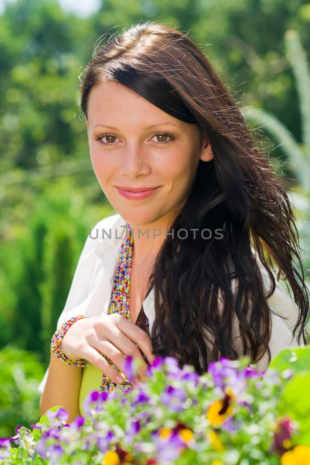 Summer garden beautiful young woman smiling flowers