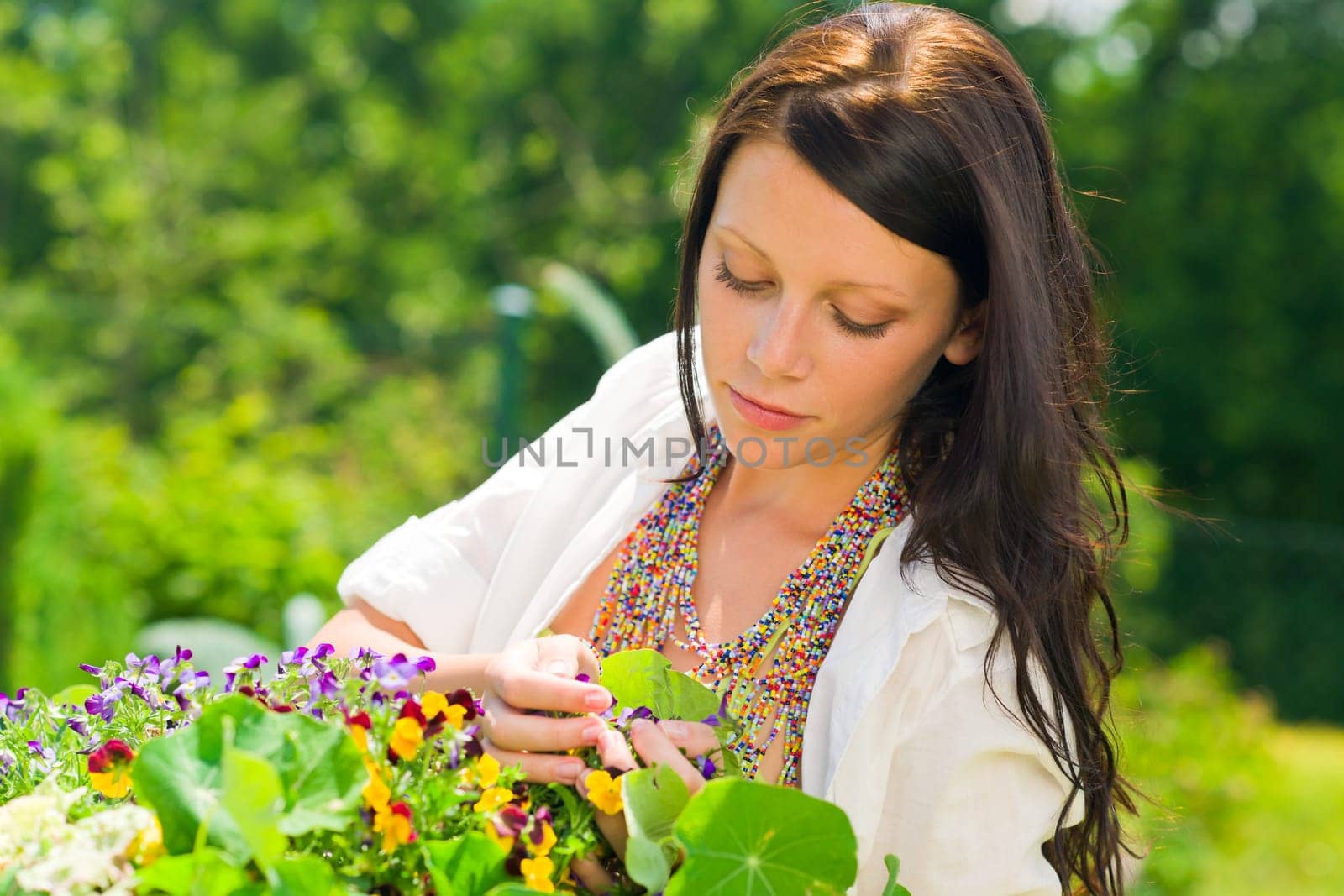 Summer garden beautiful young romantic woman with colorful flower portrait