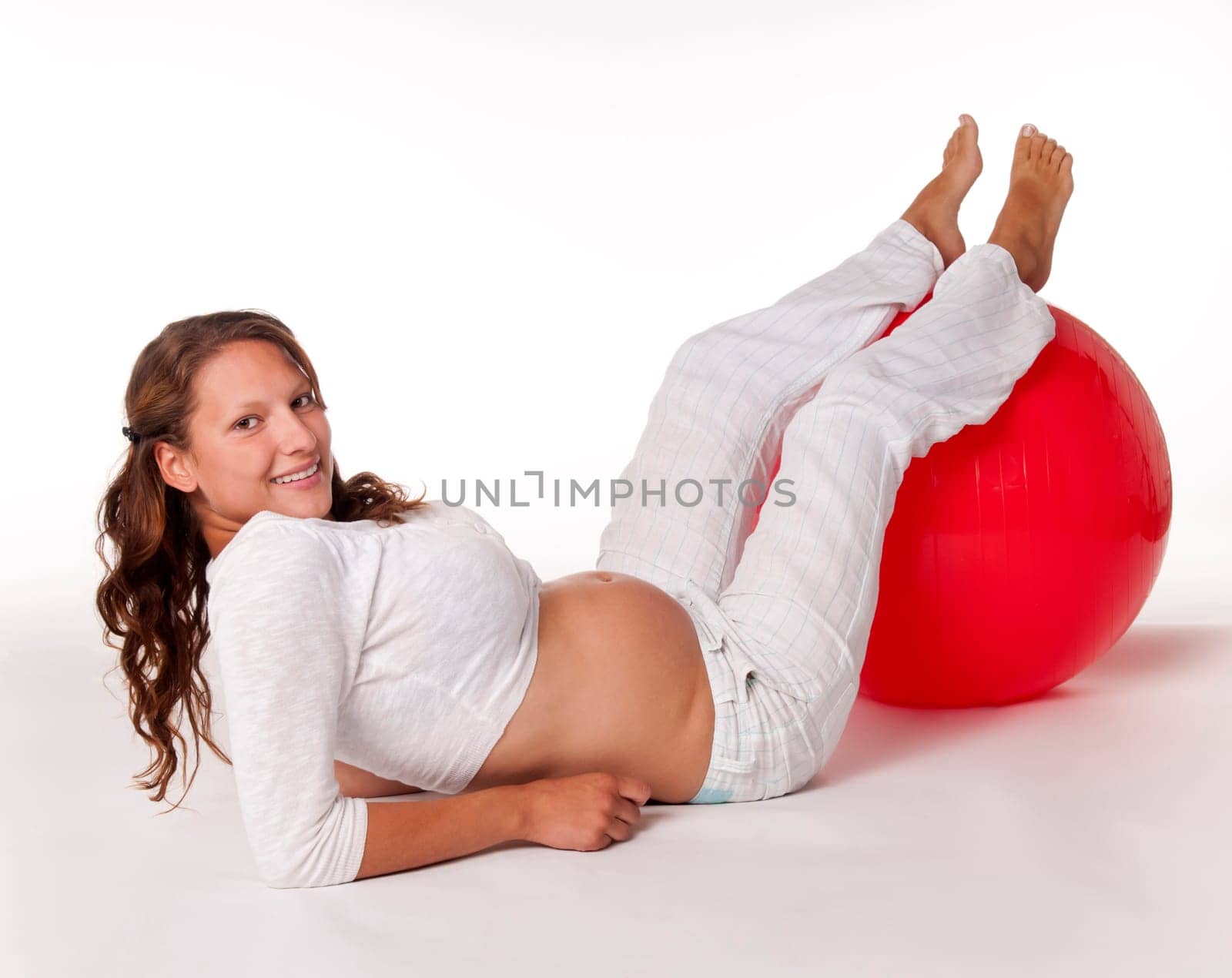 Pregnant young woman with ball