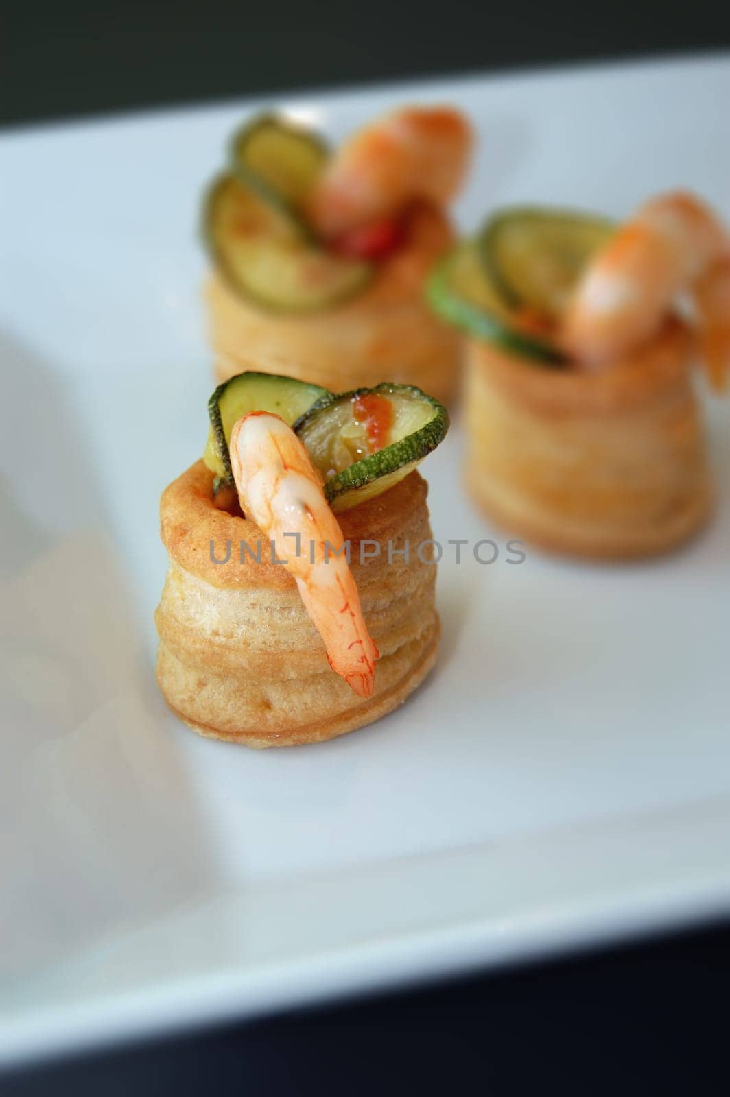 appetizer with Zucchini and shrimps on a white plate