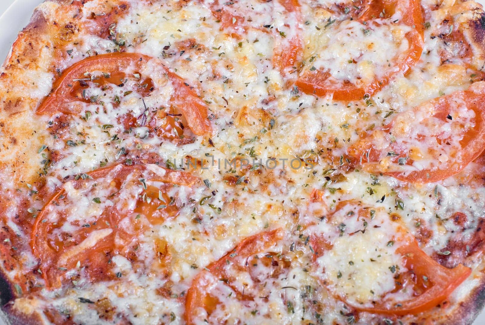 Tomato pizza with tomatoes and spicery closeup