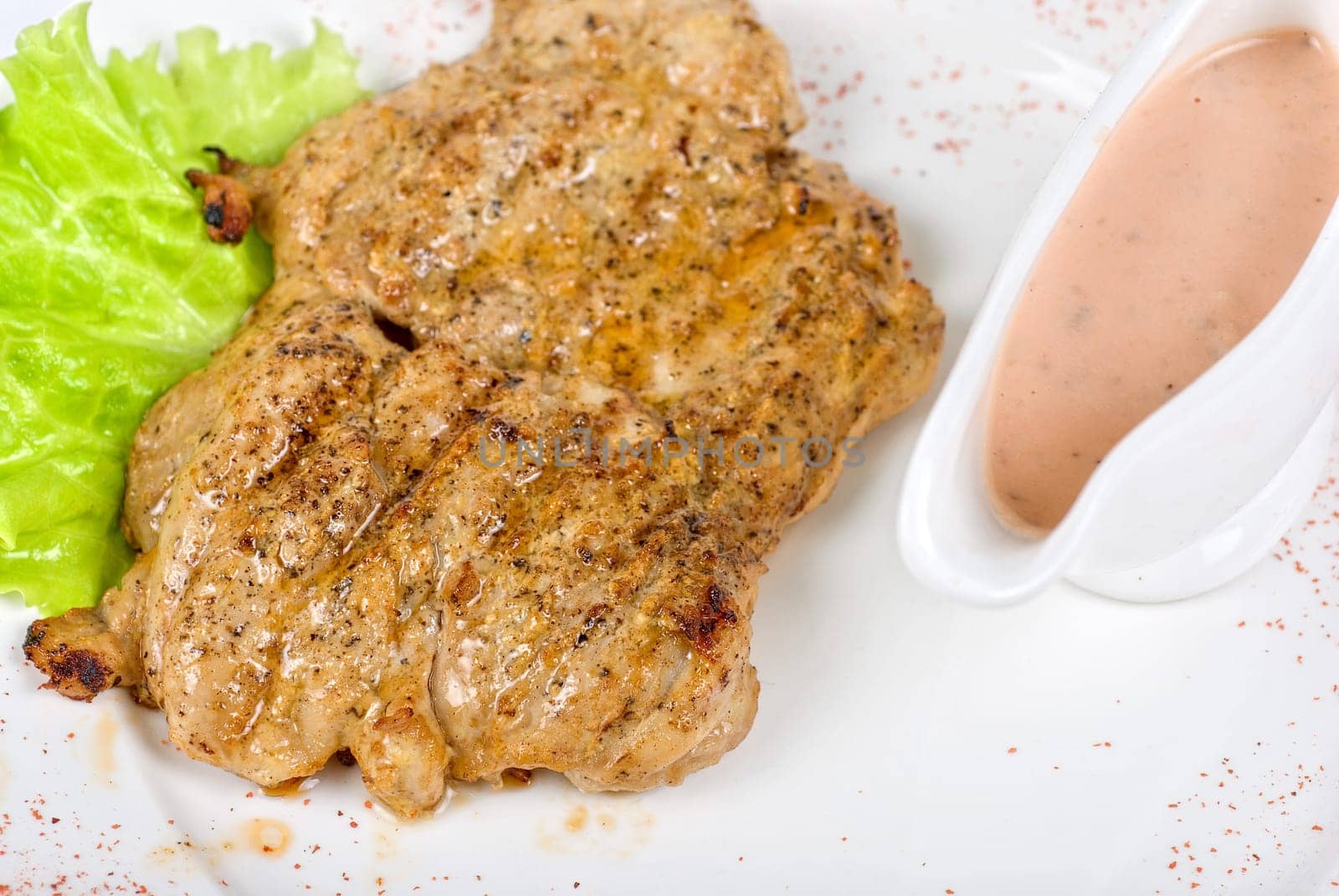 roasted chicken meat with sauce and lettuce