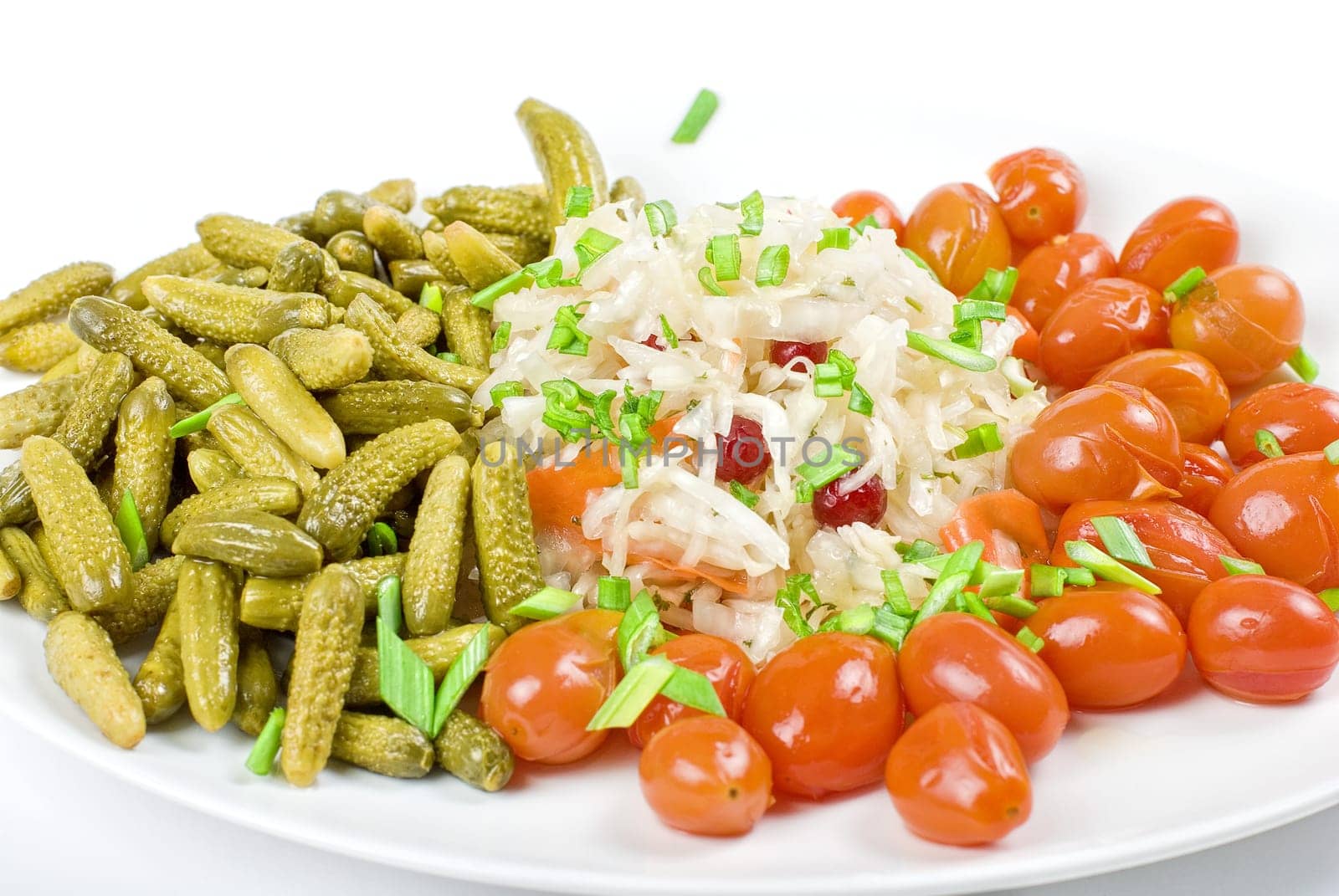 Marinated vegetables closeup at the plate isolated on a white background