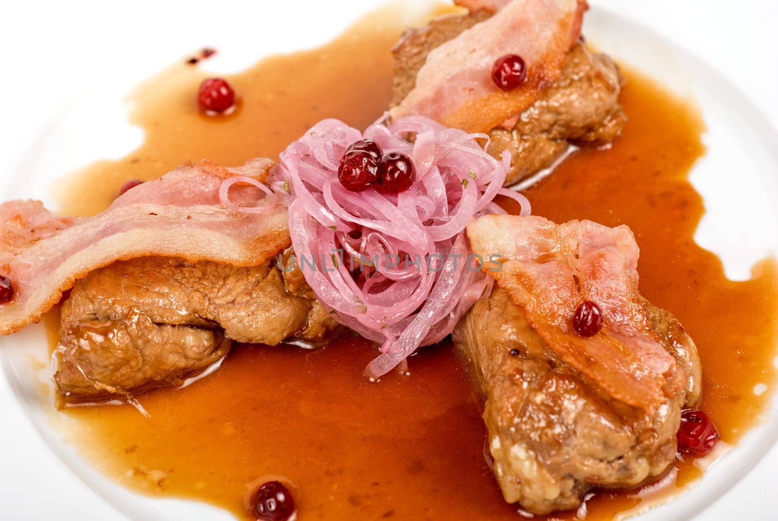 Roast pork meat with bacon, onion and cranberries