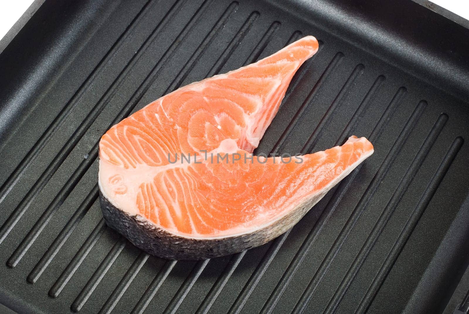 trout steak at grill pan on a white background