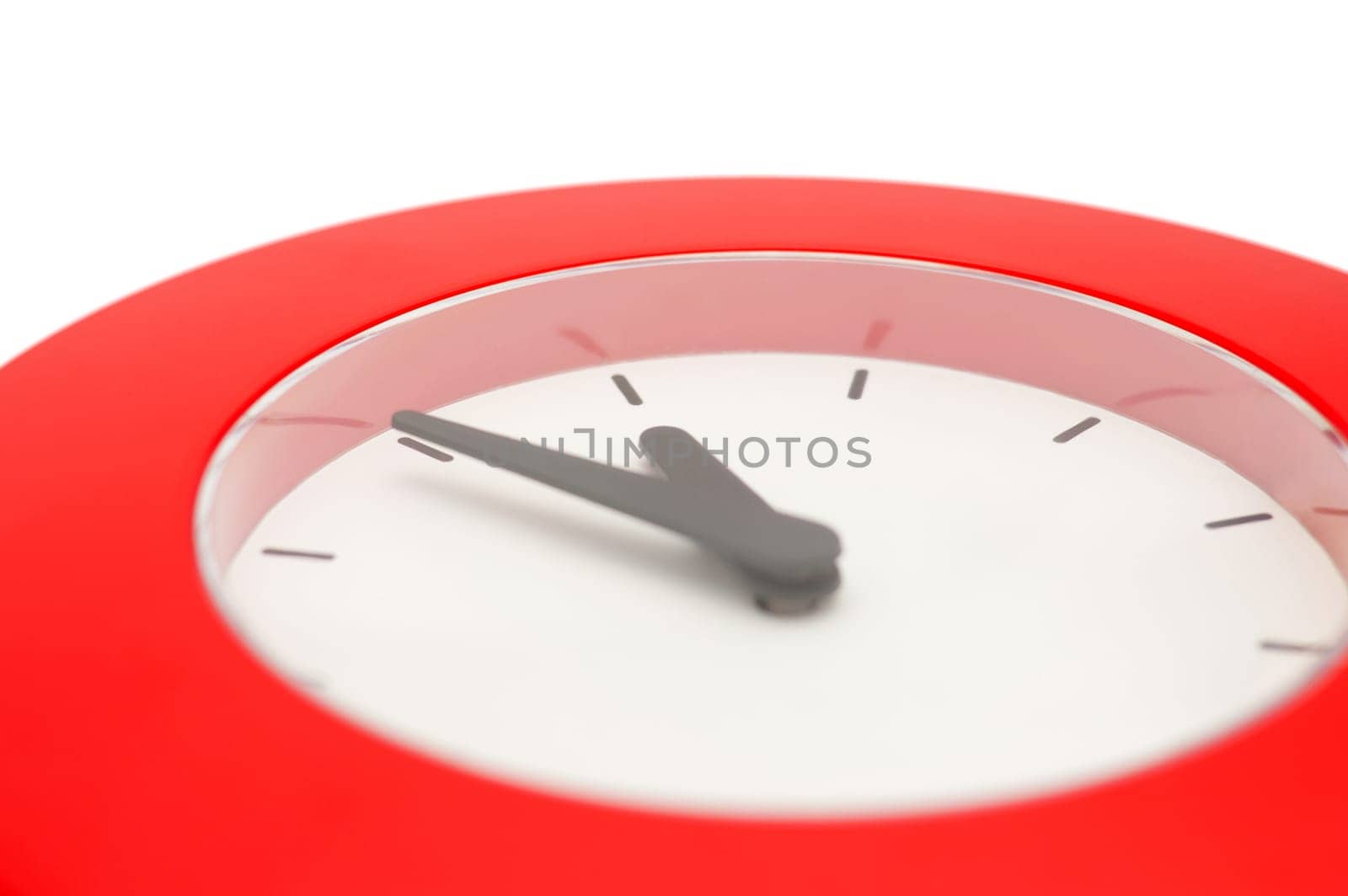 Detail of Red Wall Clock Showing Five To Midnight - Isolated on White