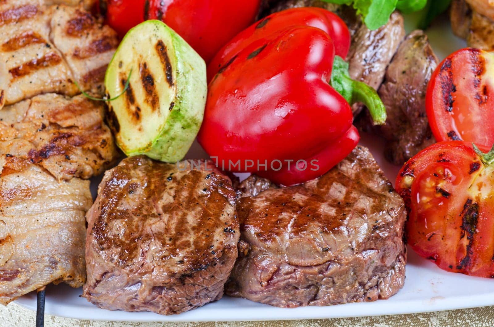 BBQ meat with vegetables and greens closeup