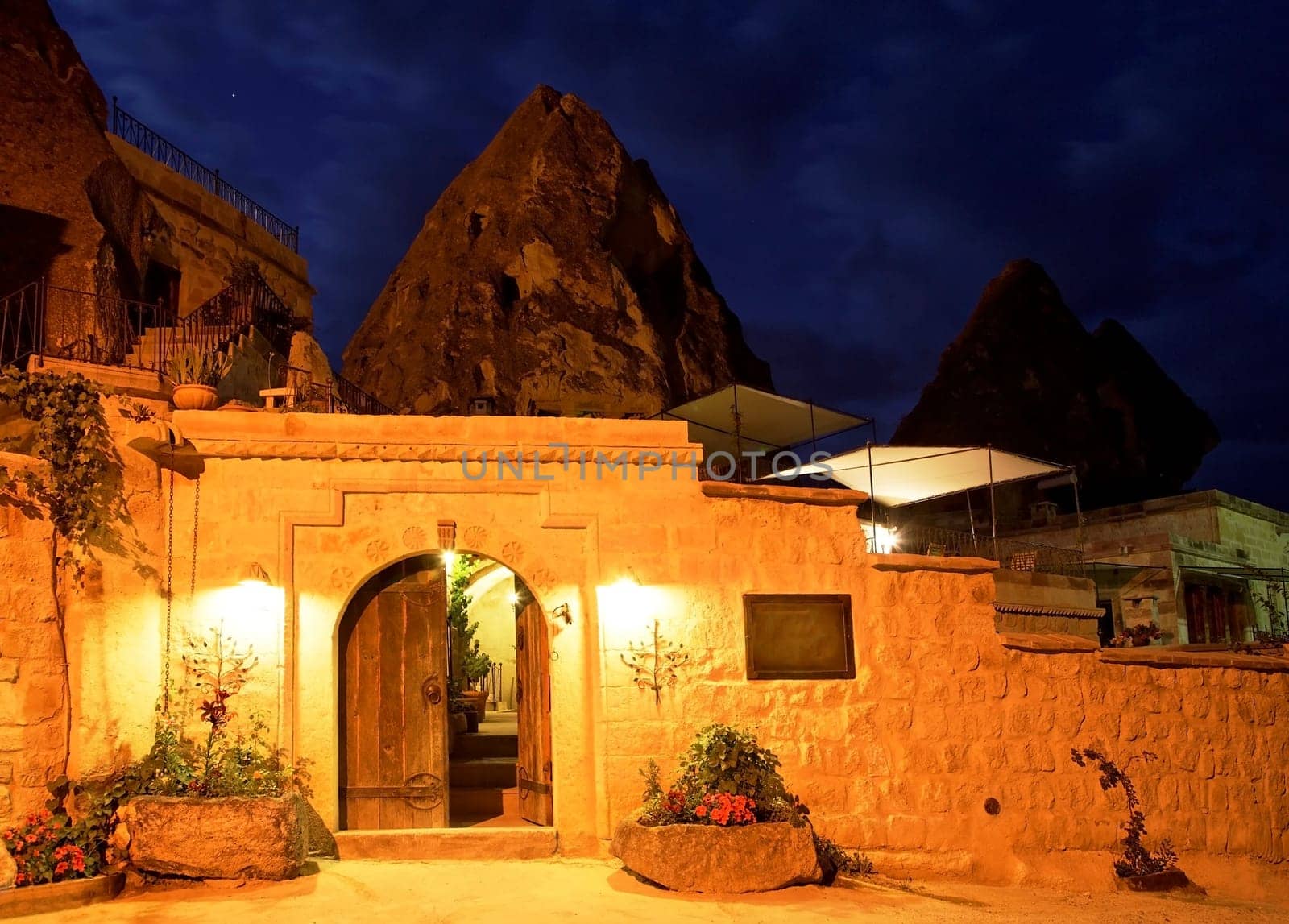 Limestone cave residence converted to a boutique hotel Goreme, Turkey. Night scene under street lights, horizontal landscape with crop area and copy space