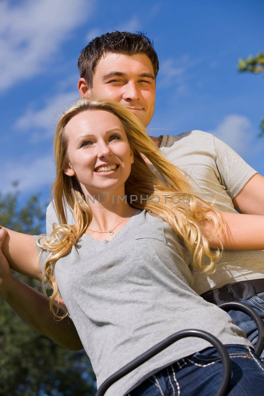 happy young couple on a swing outdoor