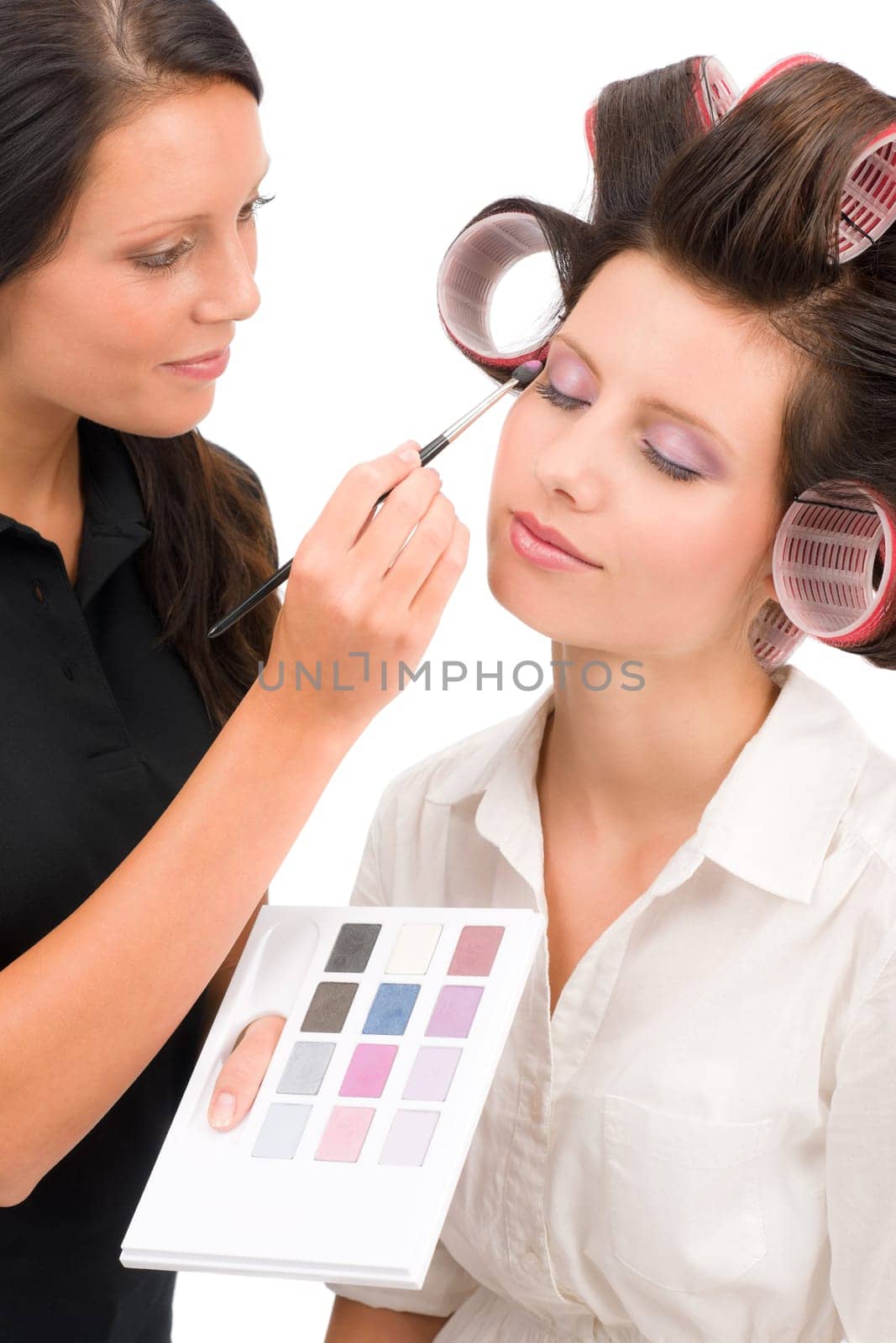 Make-up artist woman fashion model apply eyeshadow from color palette