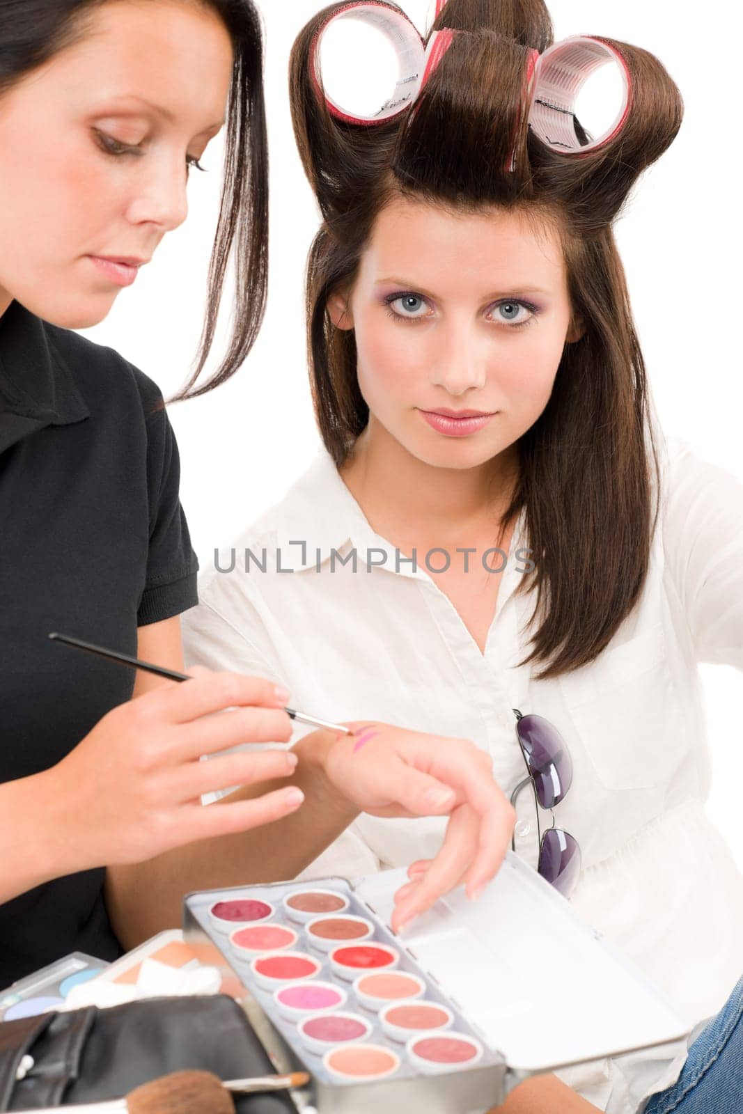 Make-up artist woman fashion model apply lipstick from color palette