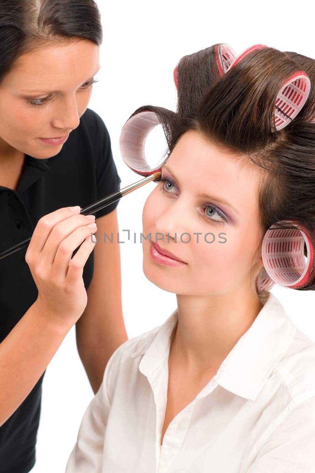 Make-up artist woman fashion model apply eyeshadow with brush