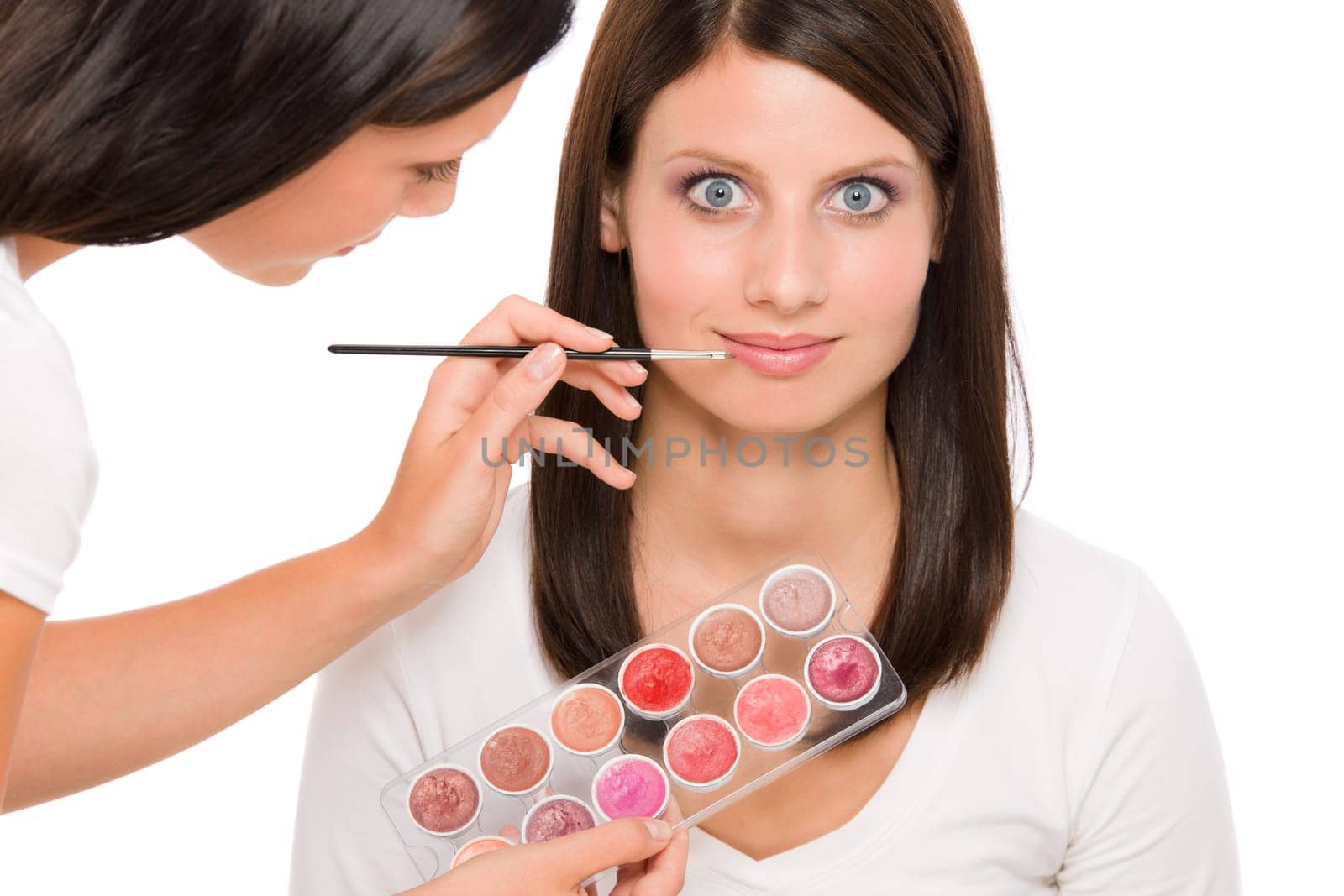 Make-up artist woman fashion model apply lipstick from color palette