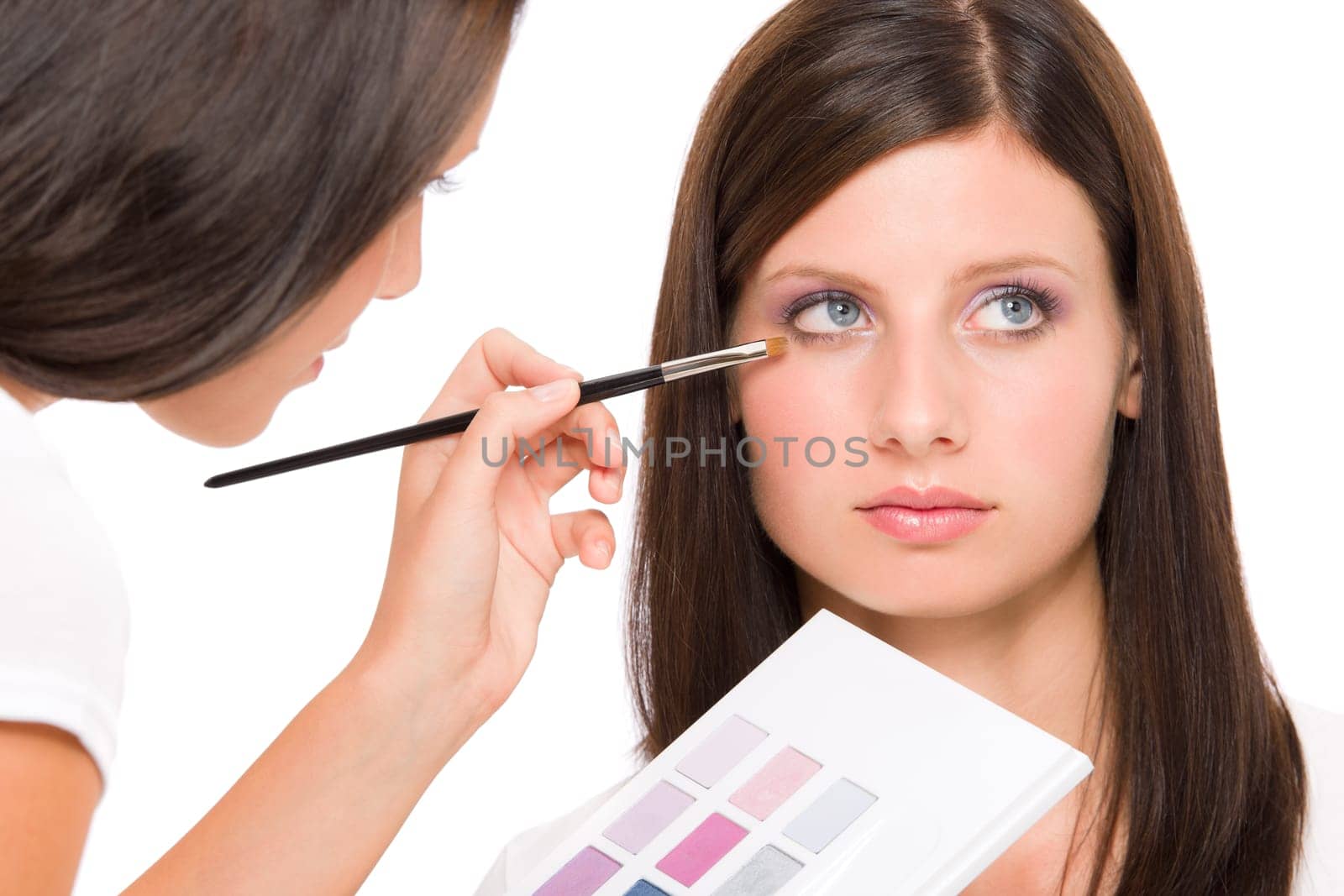Make-up artist woman fashion model apply eyeshadow from color palette