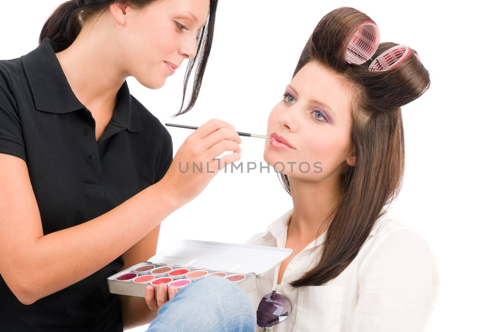 Make-up artist woman fashion model apply lipstick from color palette