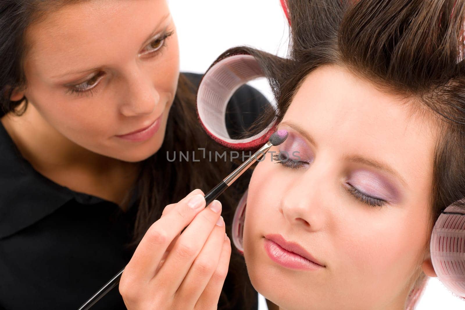 Make-up artist woman fashion model apply eyeshadow with brush