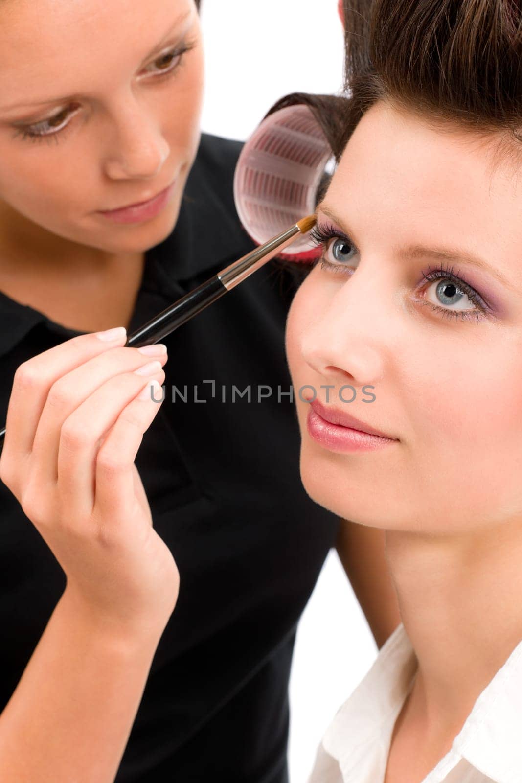 Make-up artist woman fashion model apply eyeshadow with brush