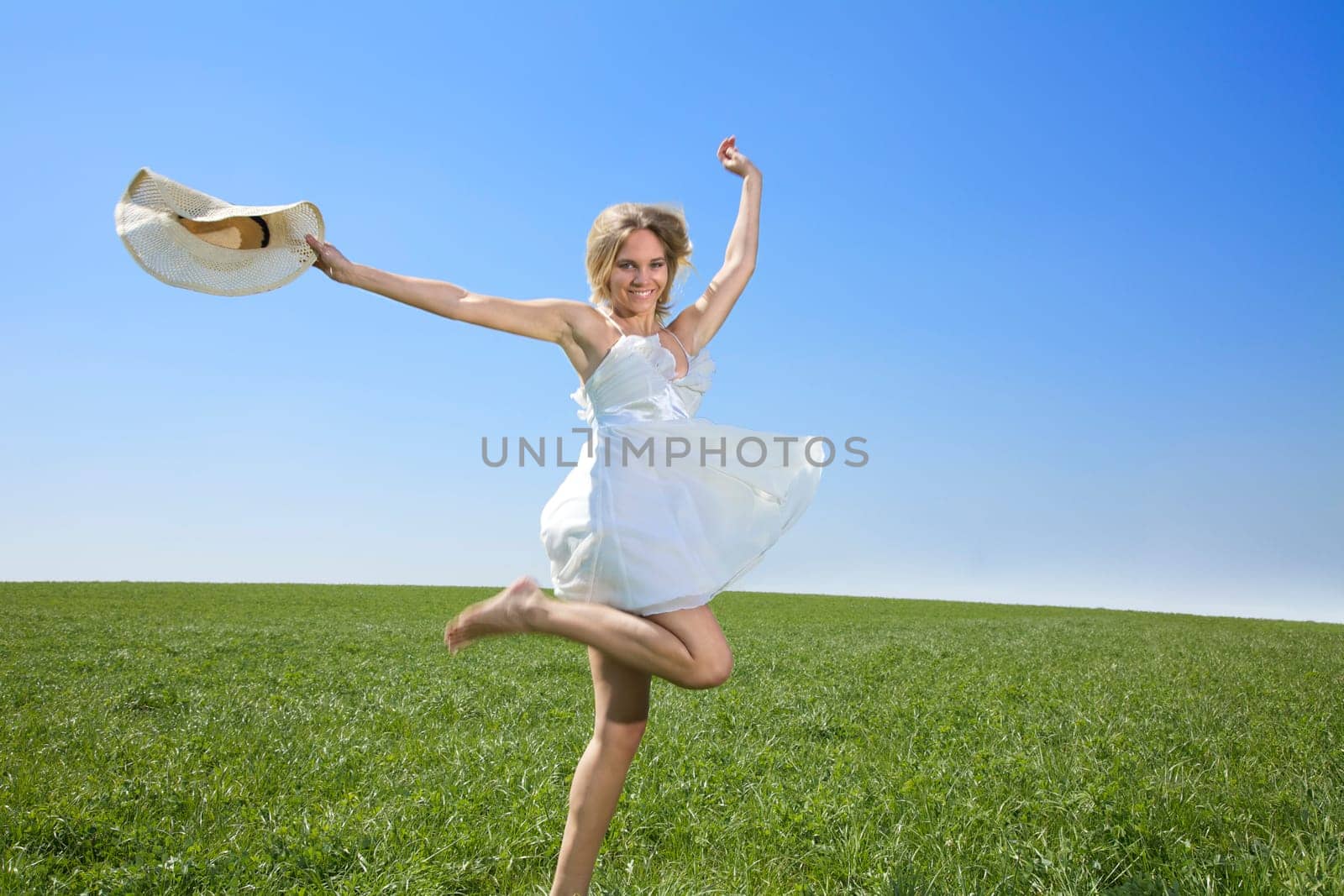 Young woman jumping / running in spring or summer