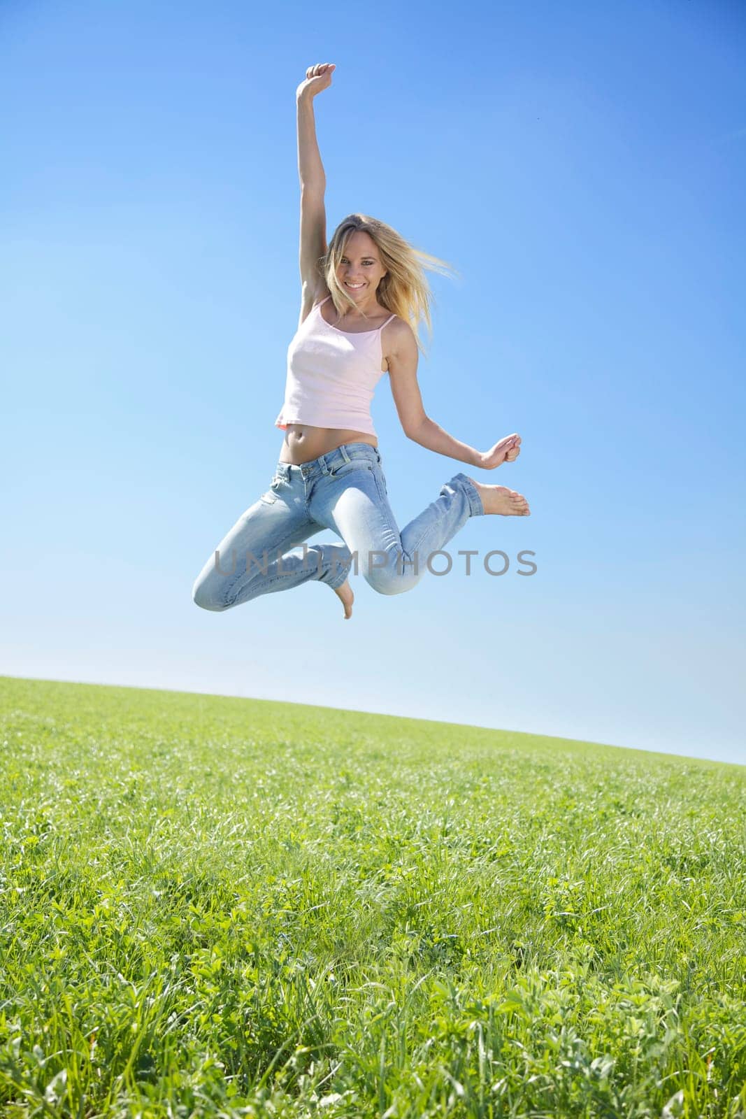 Young woman jumping in spring or summer