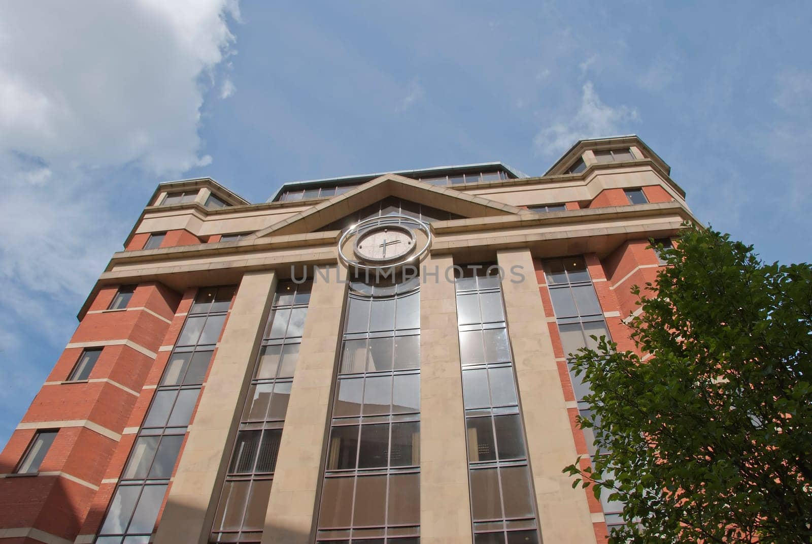 A Red Brick and Glass Office Block with Modern Clock