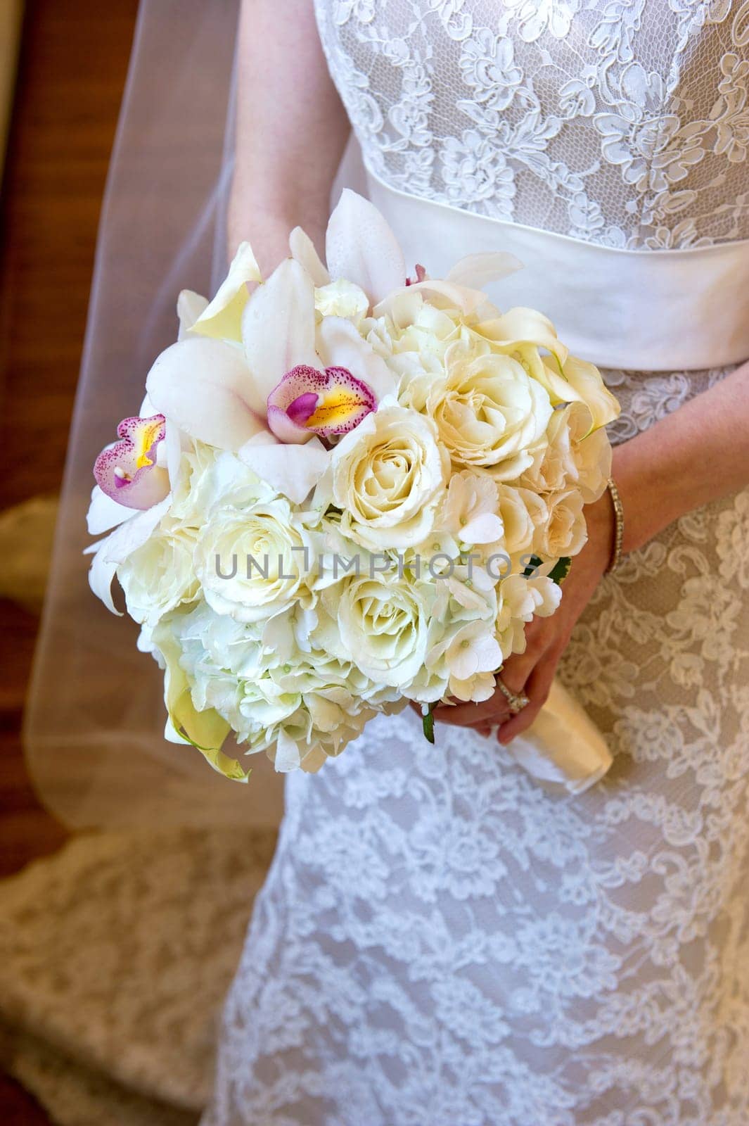 image of a wedding bouquet being held in bride&#039 s hands