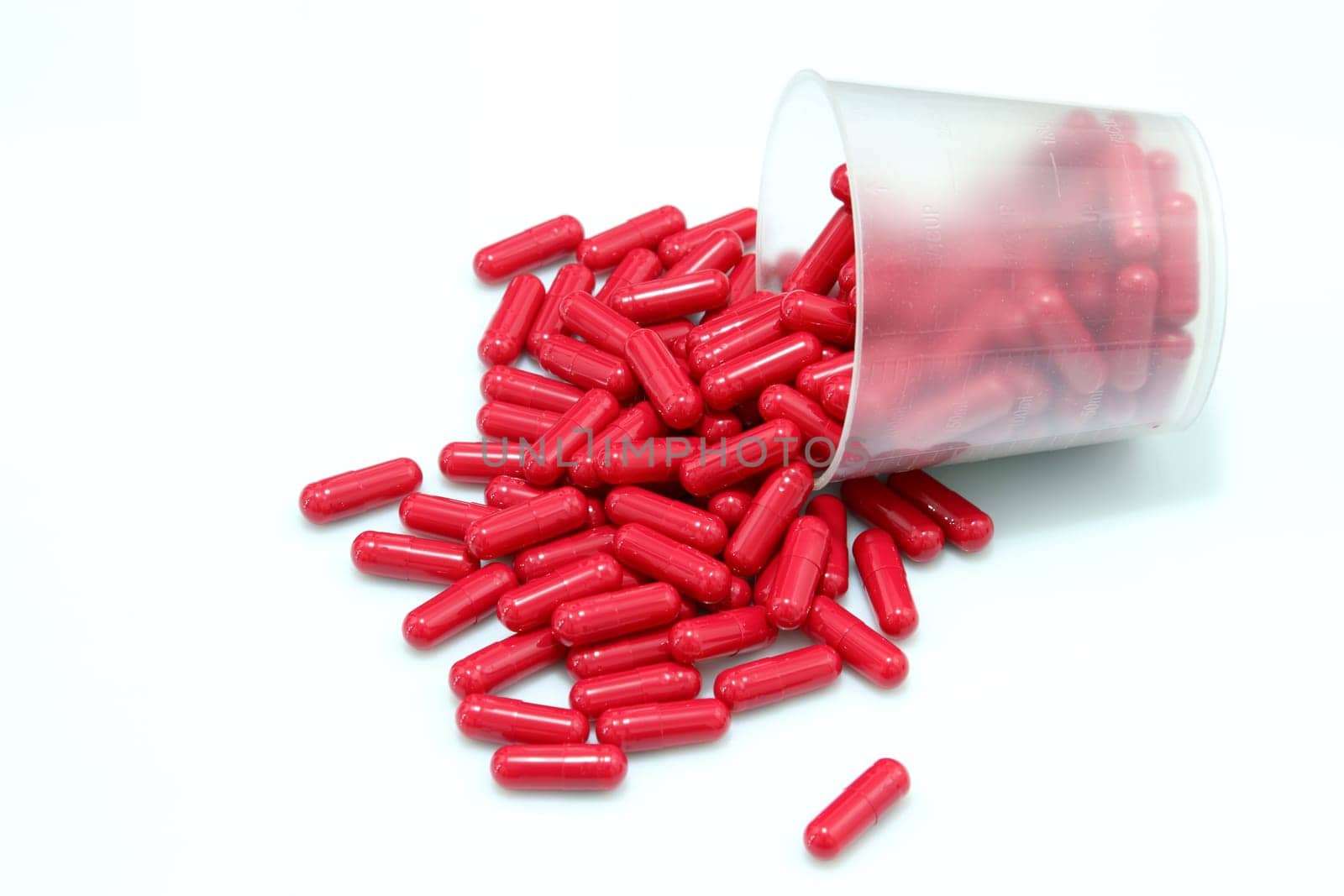 details of red pills isolated on white