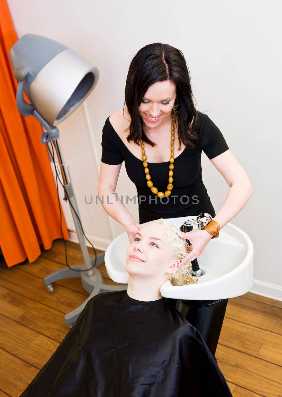 Hairdresser washing customers hair at a Beauty Spa