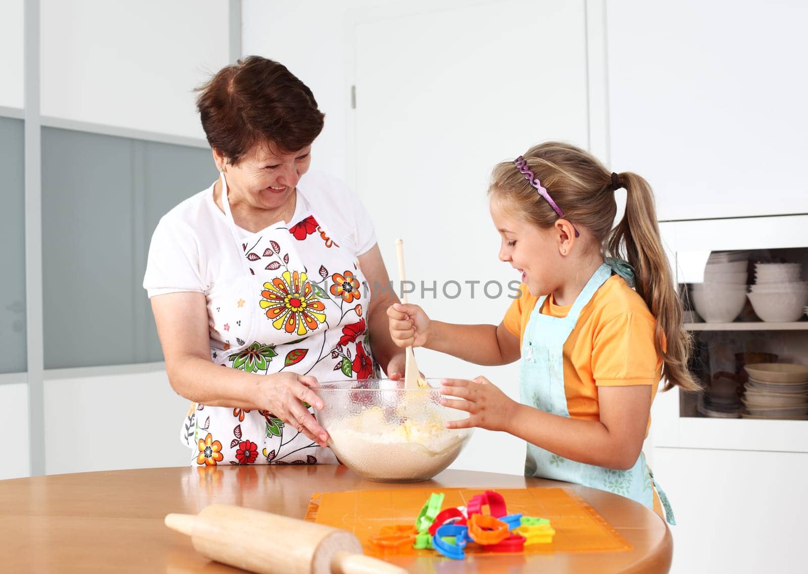Grandmother and granddaughter baking and having fun together