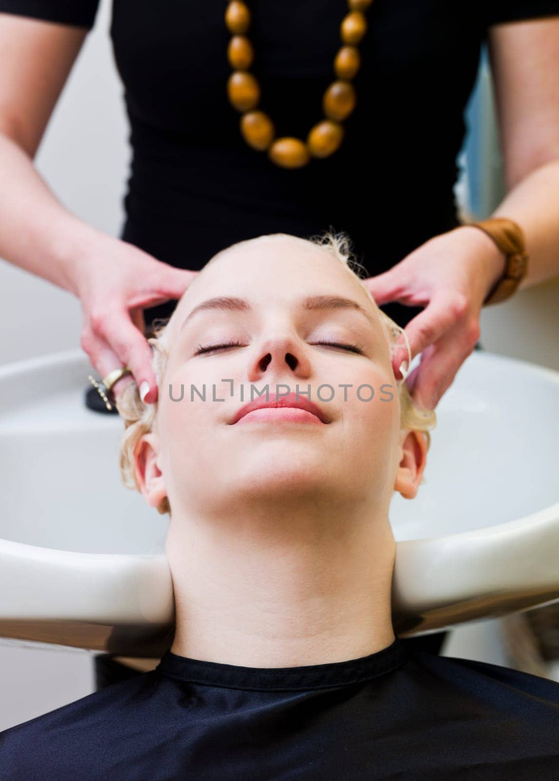 Hairdresser washing customers hair at a Beauty Spa