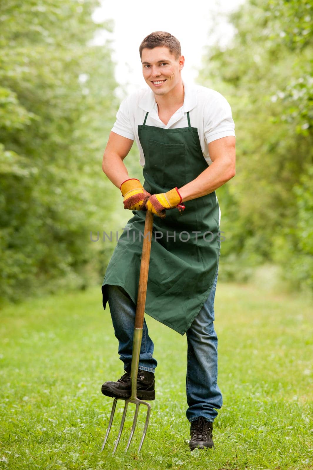 Young gardener with a compost fork