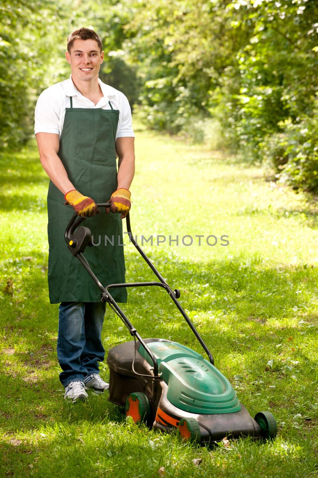 Young gardener with a lawn mower