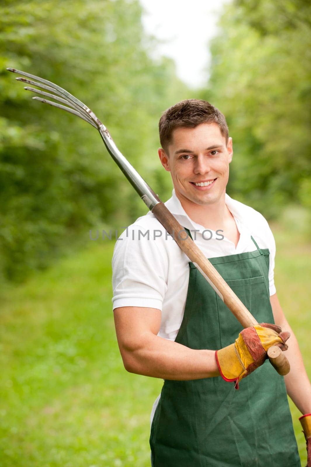 Young gardener with a compost fork