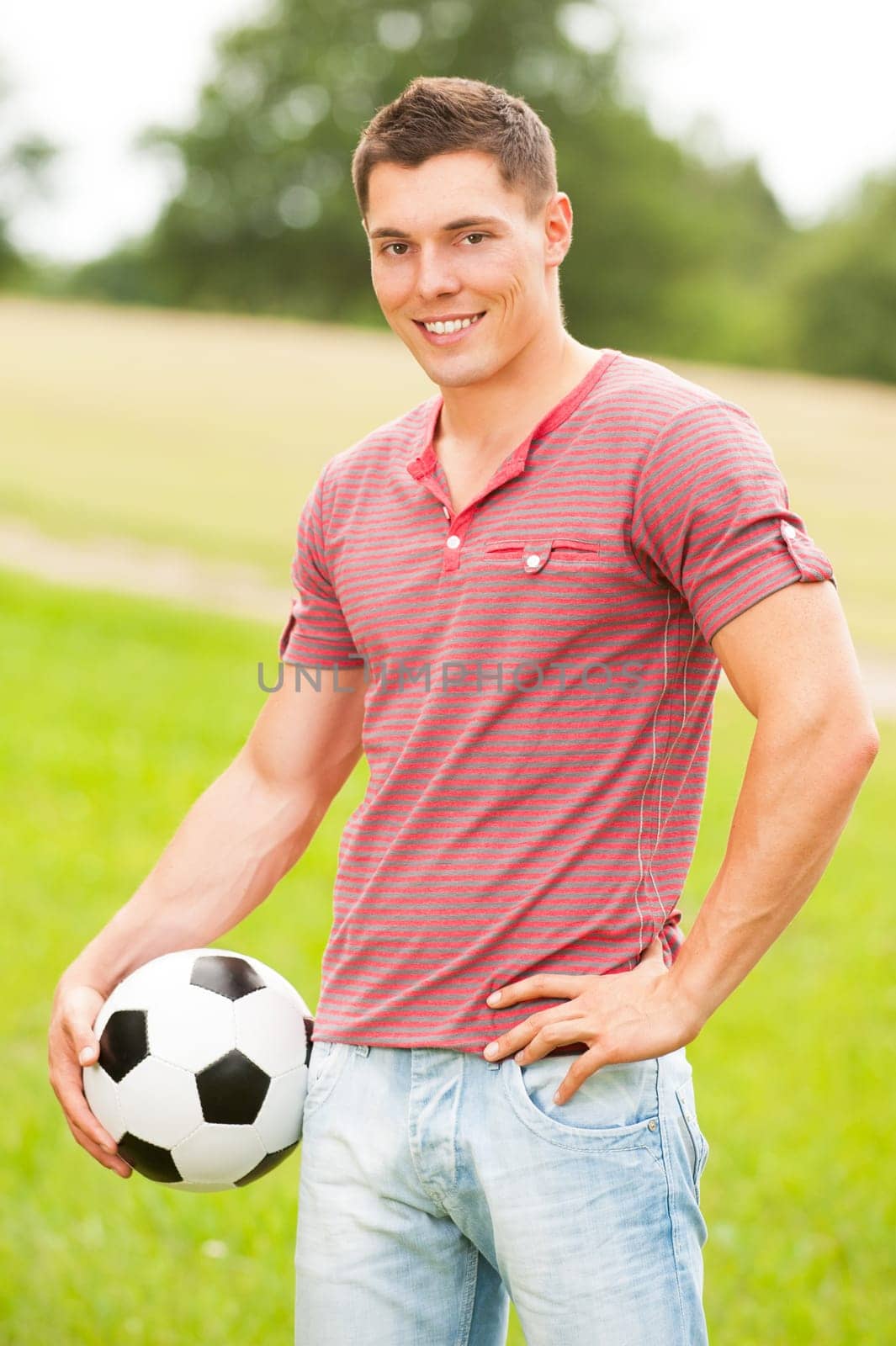 Young man in a park with soccer ball