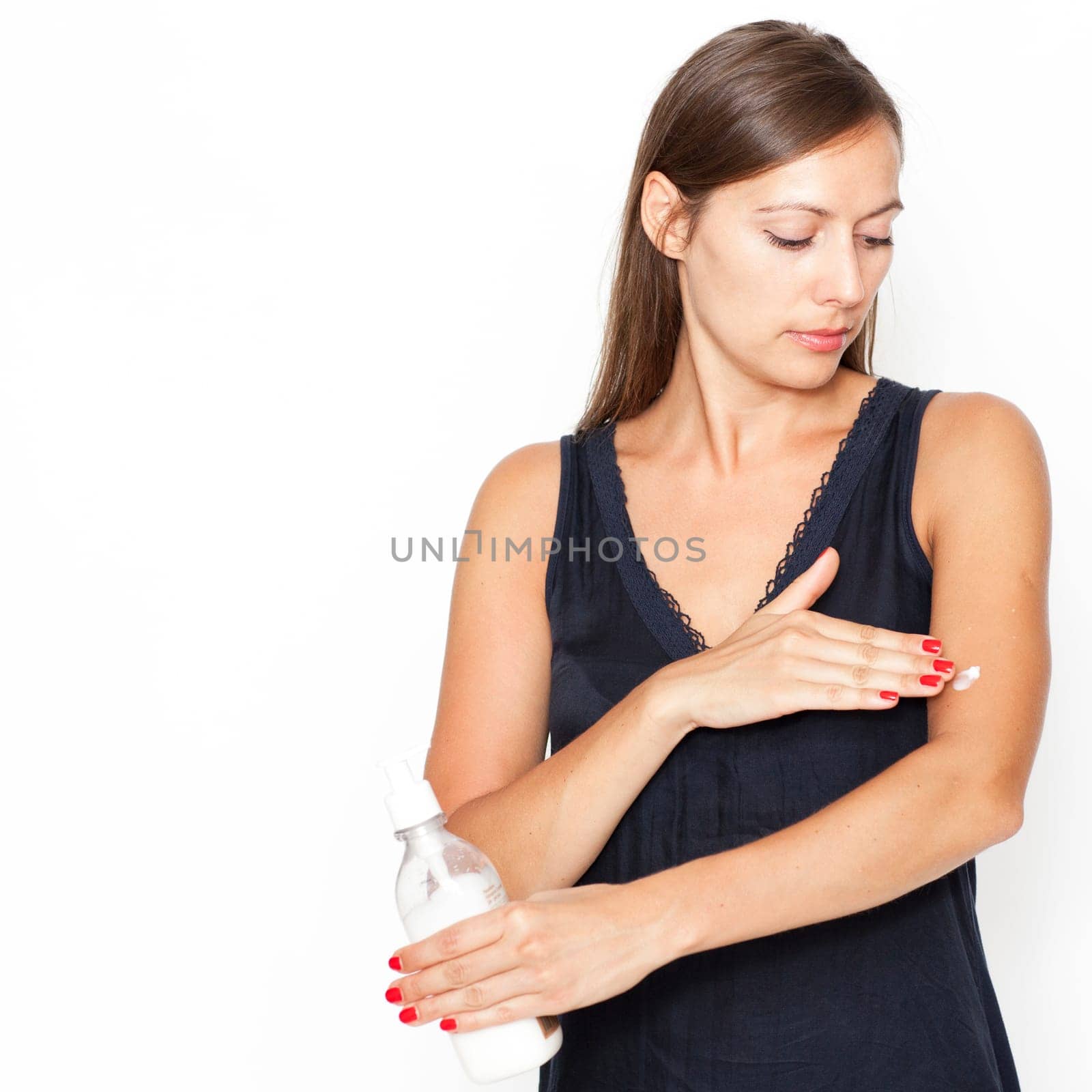 Attractive woman applying cream