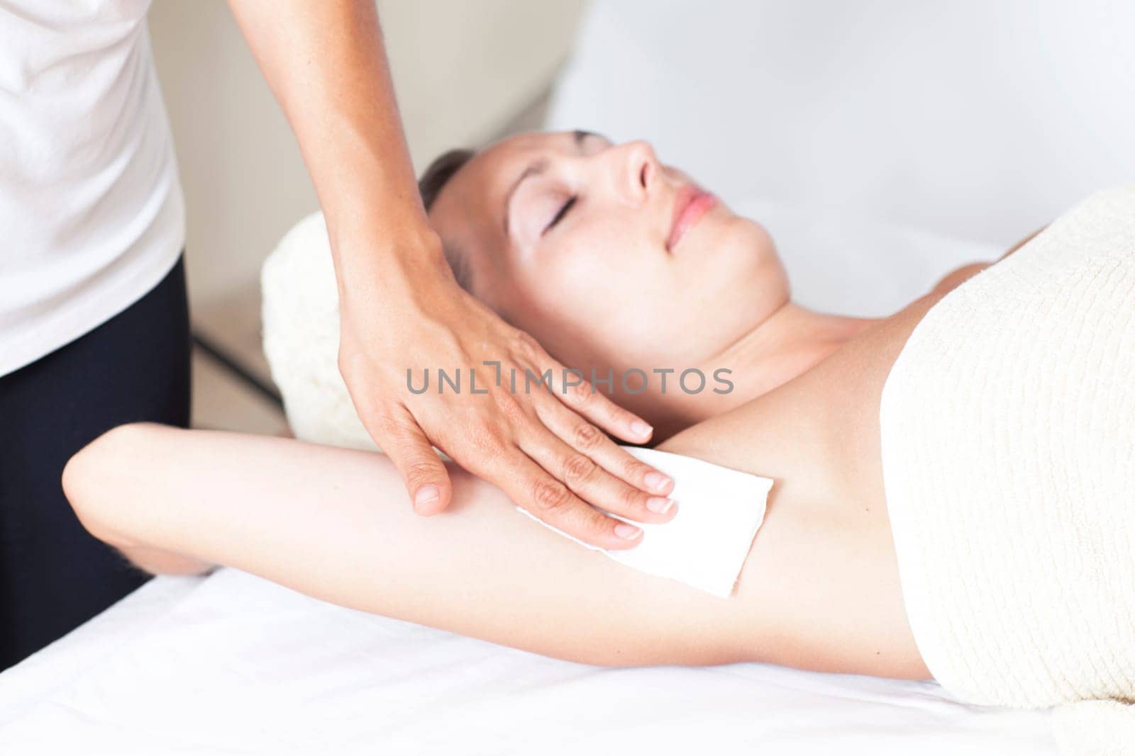 Woman with depilation of the armpit