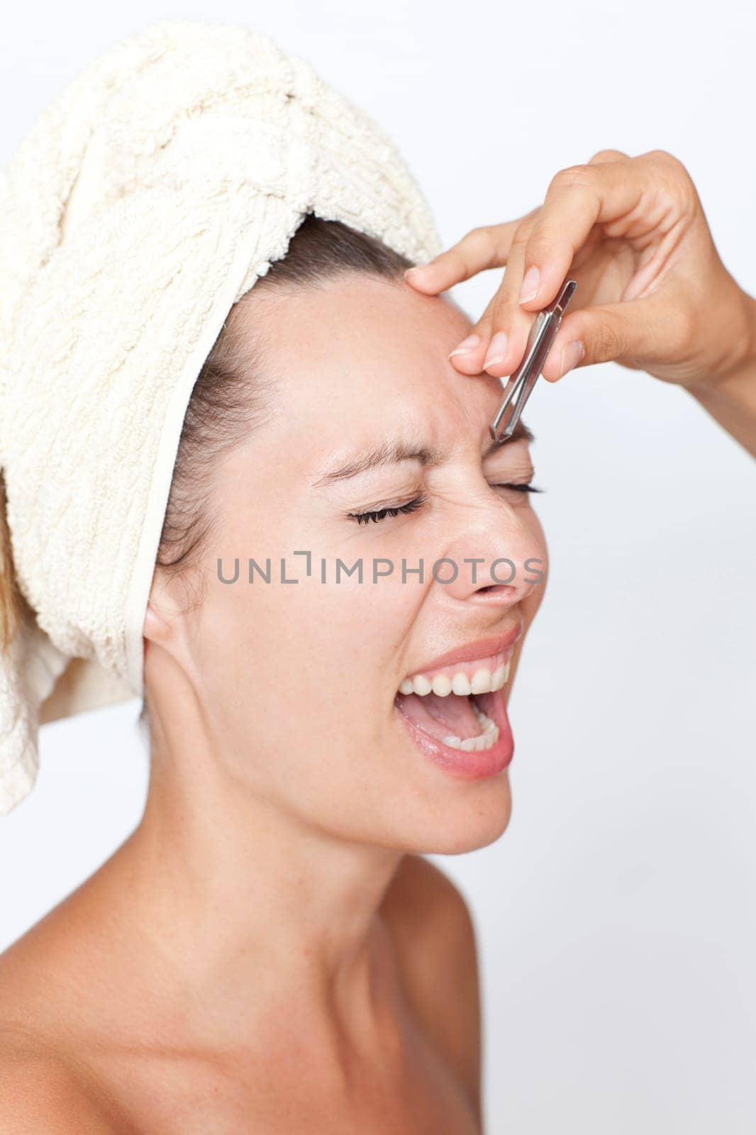Woman plucking eyebrows