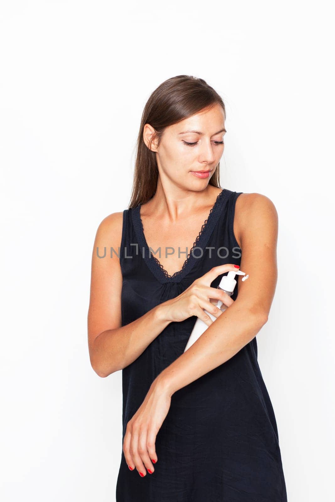 Attractive woman applying cream