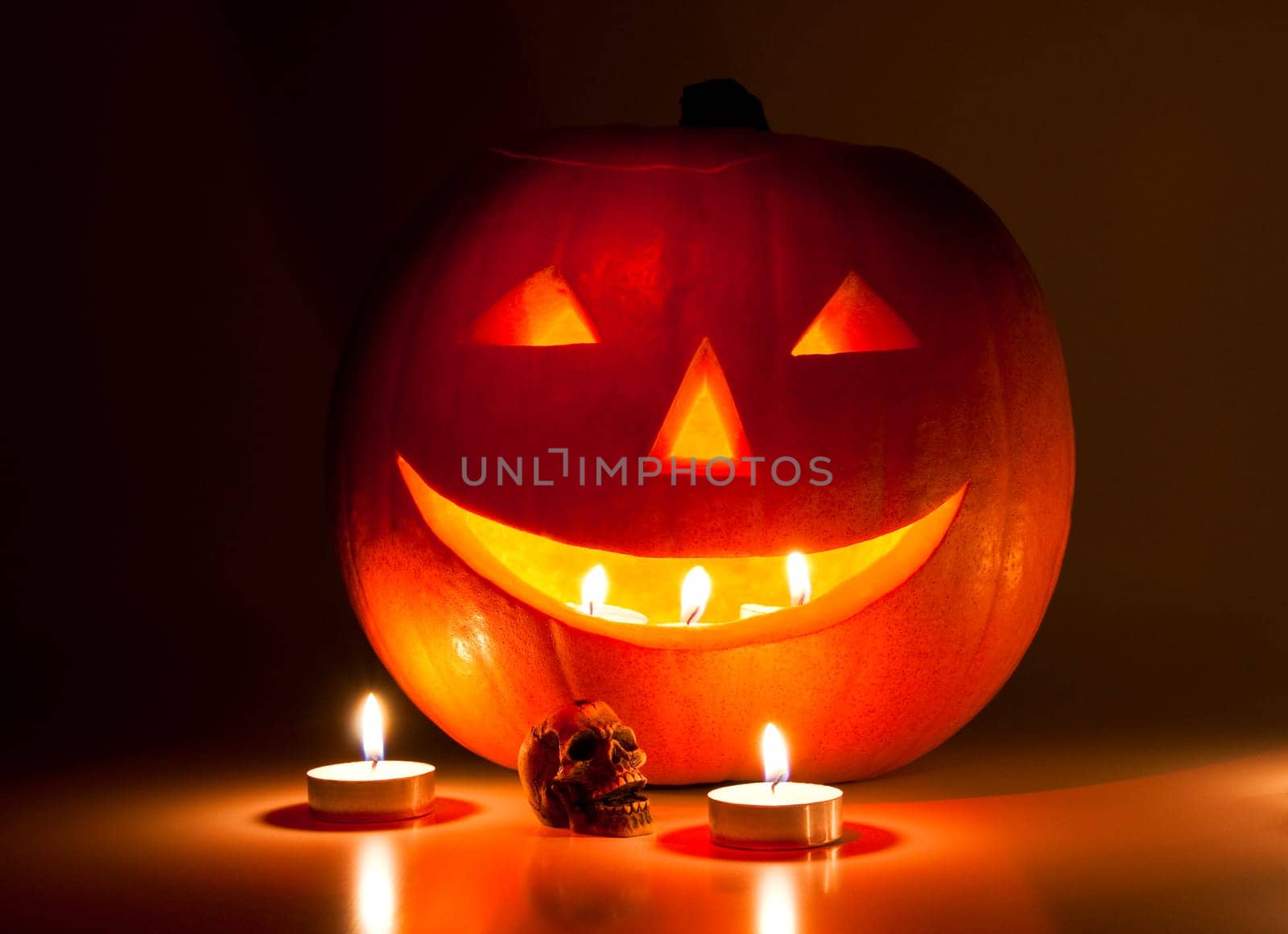 Halloween lantern and a small skull lit by candles