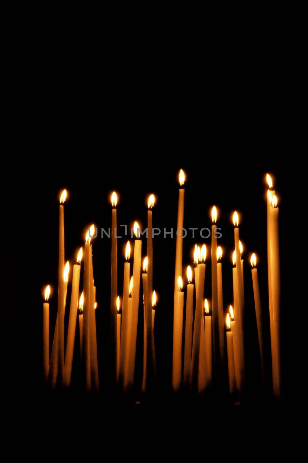 Candles in a church, black background