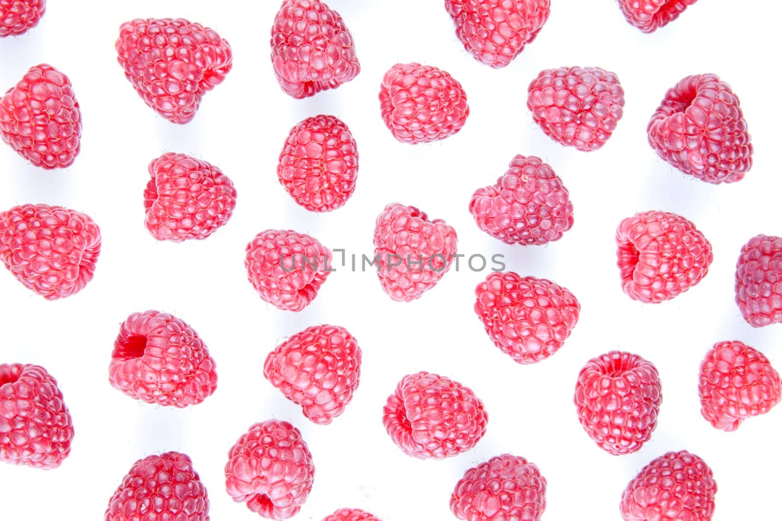 Fresh raspberries scattering on a white background